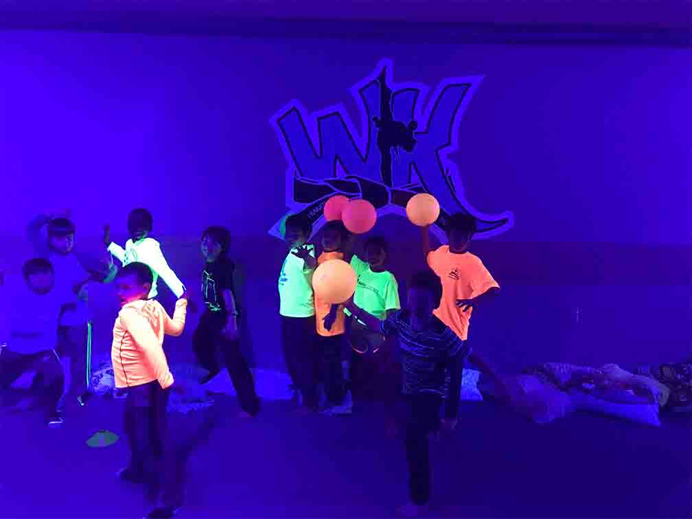 kids playing balloons wearing glow in the dark world karate fairfax's uniform
