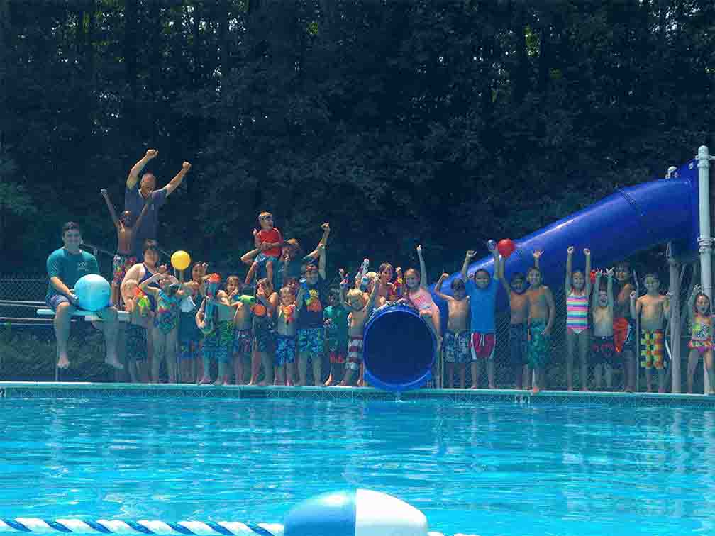 kids posting for picture during their weekend swimming activity at WKFairfax summer camp for kids in Virginia